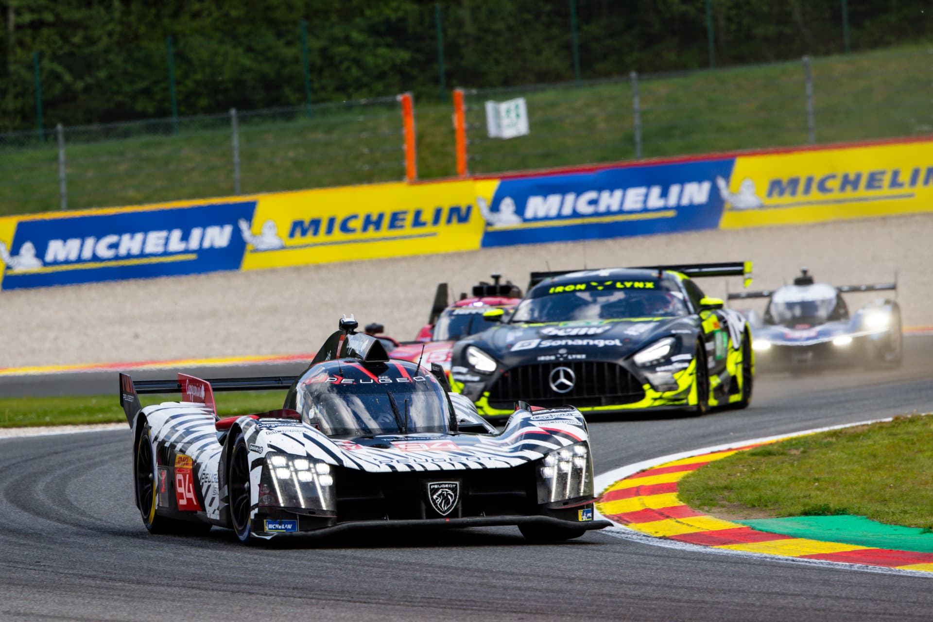 Peugeot 9X8 Hypercar leads an Iron Lynx Mercedes-AMG GT3 through Spa-Francorchamps